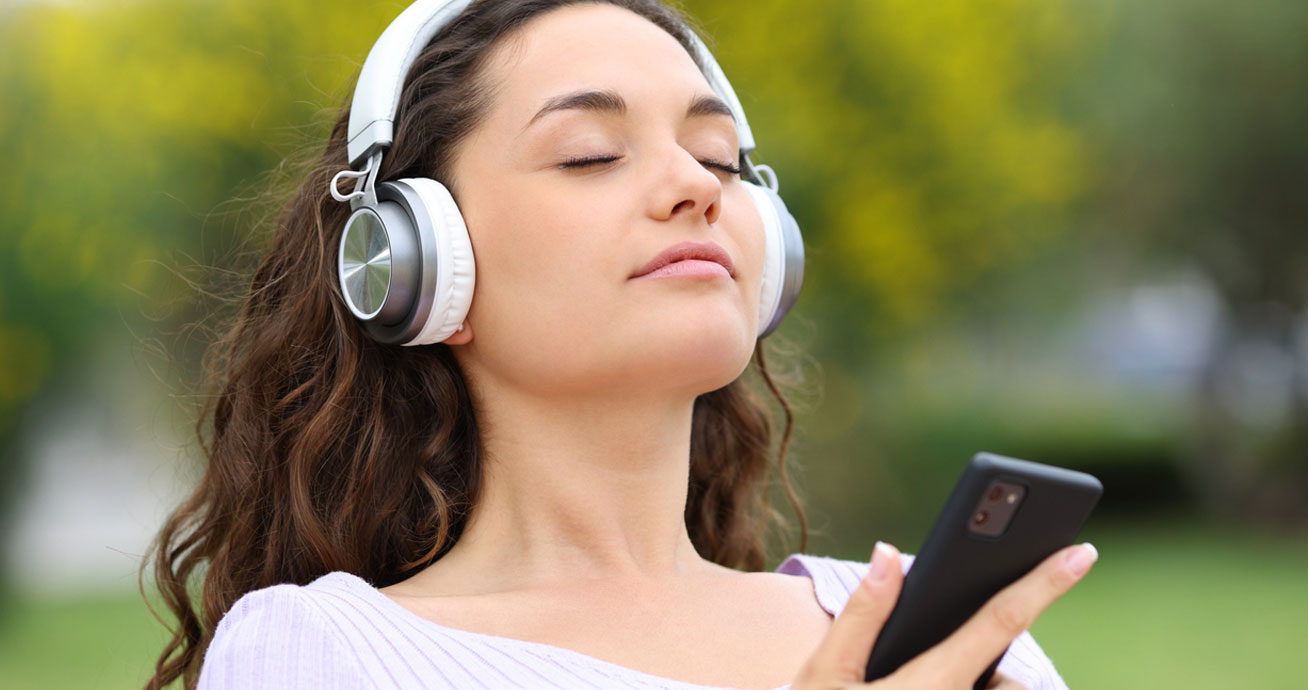 woman-with-headphones-during-guided-session-outdoors